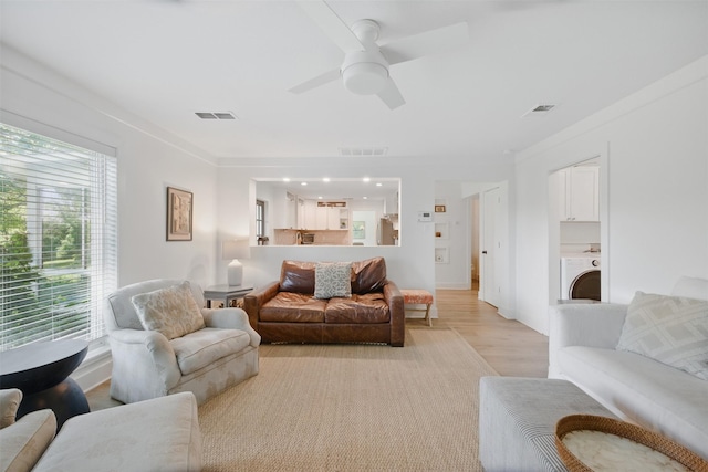 2006 Country Oaks Dr, Garland, TX 75040 - living area with washer / clothes dryer, a ceiling fan, and light wood-style floors