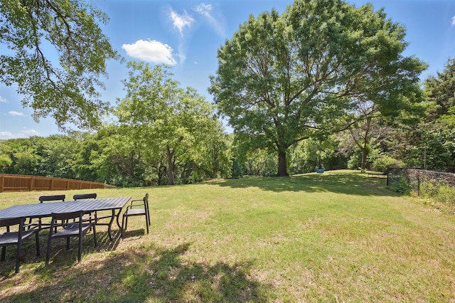 2006 Country Oaks Dr, Garland, TX 75040 - view of yard featuring outdoor dining area and a wooded view