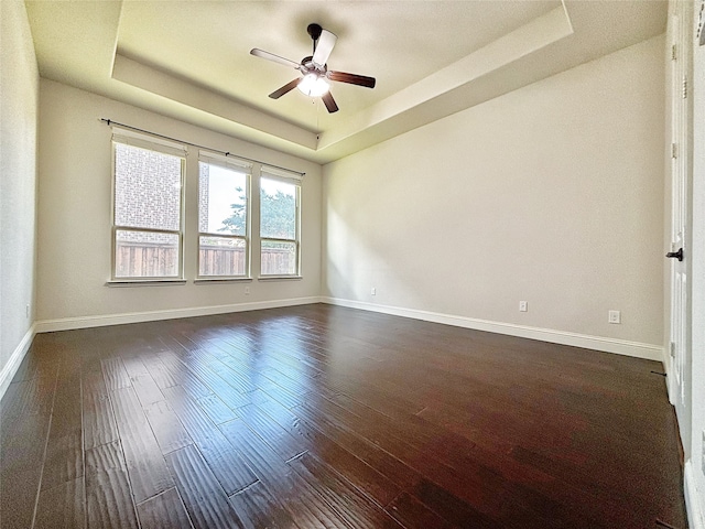 3037 Crestwater Rdg, Keller, TX 76248 - spare room with a tray ceiling, dark wood-style floors, a ceiling fan, and baseboards