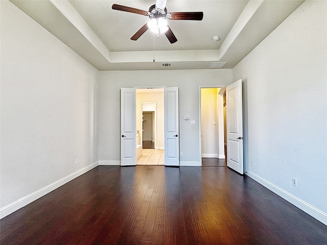 3037 Crestwater Rdg, Keller, TX 76248 - unfurnished bedroom with a raised ceiling, wood finished floors, and baseboards