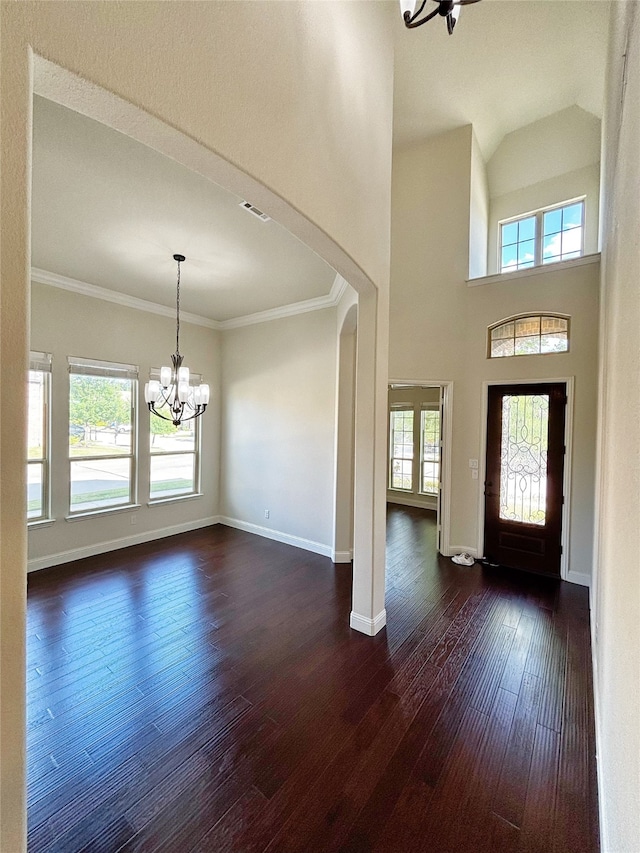 3037 Crestwater Rdg, Keller, TX 76248 - entrance foyer featuring a chandelier, dark wood-style floors, arched walkways, baseboards, and crown molding
