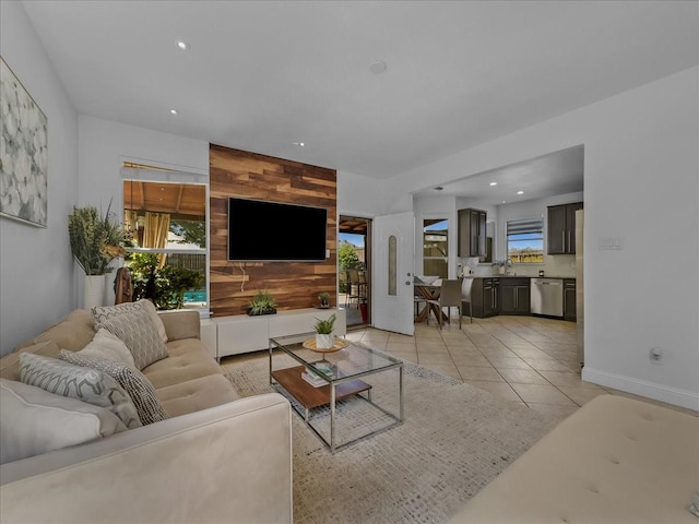living room featuring light tile patterned floors, wooden walls, recessed lighting, and baseboards