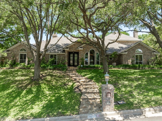 3740 Chimney Ridge Dr, Waco, TX 76708 - traditional home with a chimney, a front lawn, and brick siding