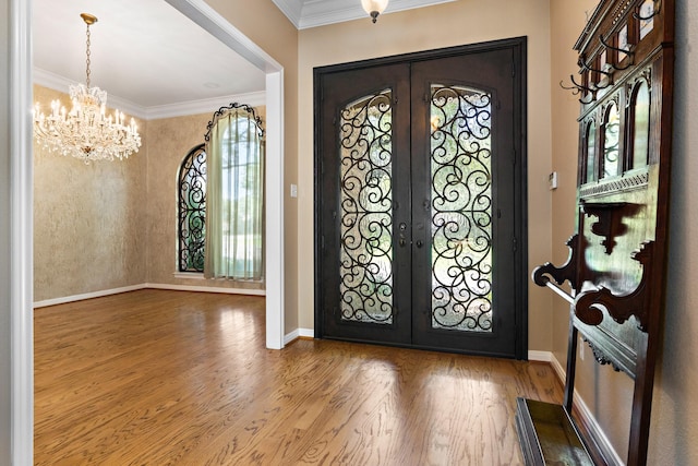 3740 Chimney Ridge Dr, Waco, TX 76708 - foyer entrance featuring french doors, a chandelier, wood finished floors, baseboards, and crown molding