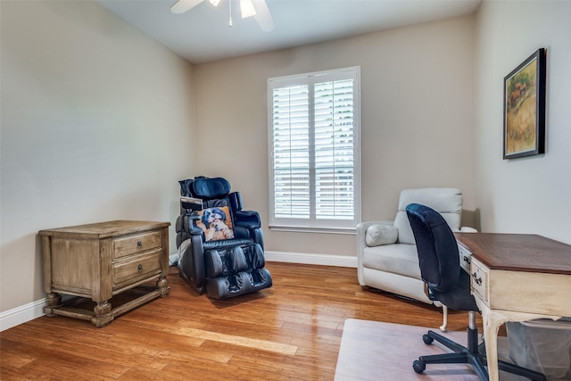 office featuring ceiling fan, light wood-style floors, and baseboards