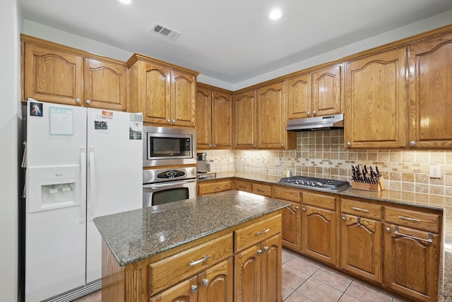 1601 Manchester Way, Corinth, TX 76210 - kitchen featuring appliances with stainless steel finishes, under cabinet range hood, and brown cabinets