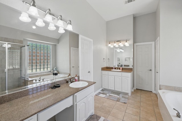 1601 Manchester Way, Corinth, TX 76210 - full bath with a stall shower, a bath, vanity, tile patterned flooring, and a towering ceiling