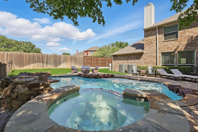 1601 Manchester Way, Corinth, TX 76210 - view of pool with central AC unit, a pool with connected hot tub, and a fenced backyard
