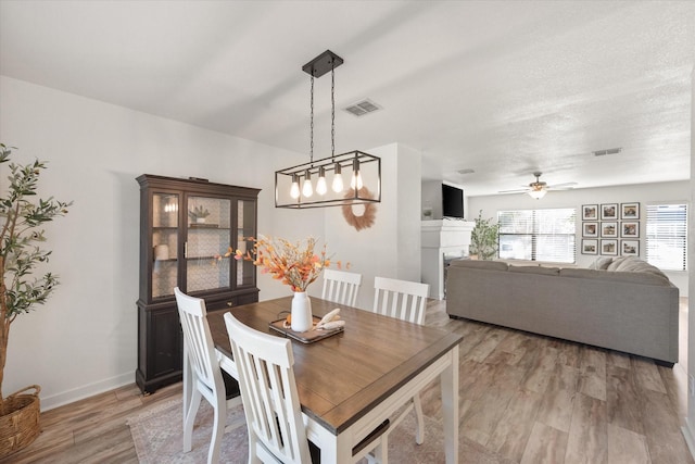 6612 Oldgate Ln, Arlington, TX 76002 - dining area with light wood finished floors, a ceiling fan, and baseboards