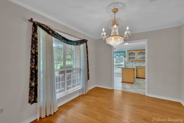1403 Whispering Pines Dr, Minden, LA 71055 - unfurnished dining area featuring a chandelier, light wood finished floors, baseboards, and crown molding