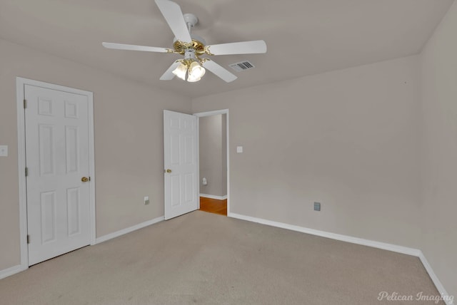1403 Whispering Pines Dr, Minden, LA 71055 - unfurnished bedroom with carpet floors, baseboards, and a ceiling fan