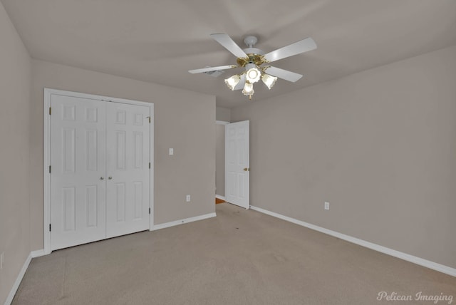 1403 Whispering Pines Dr, Minden, LA 71055 - unfurnished bedroom with baseboards, carpet flooring, a closet, and ceiling fan