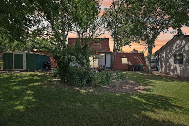 203 Goodson Way, Denton, TX 76207 - yard at dusk with a yard, a storage shed, and an outdoor structure