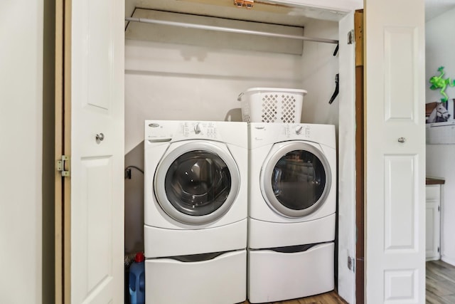 203 Goodson Way, Denton, TX 76207 - clothes washing area with washer and dryer and wood finished floors