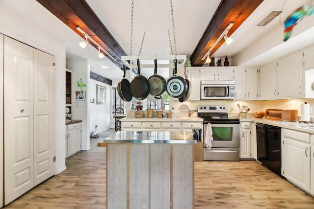203 Goodson Way, Denton, TX 76207 - kitchen featuring stainless steel appliances, light wood-type flooring, beam ceiling, white cabinets, and a center island