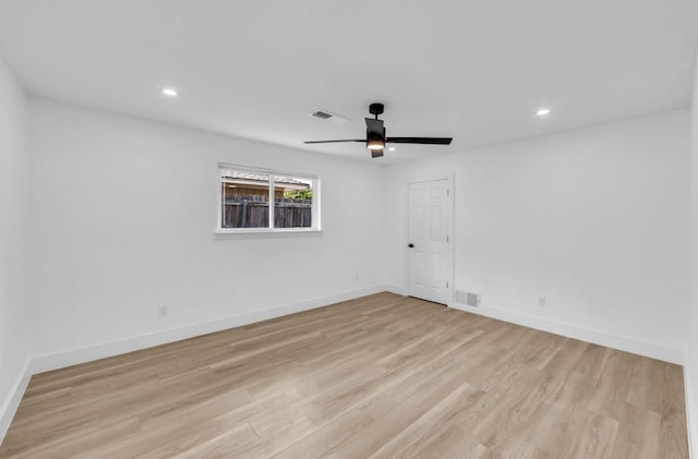 spare room with light wood finished floors, a ceiling fan, baseboards, and recessed lighting