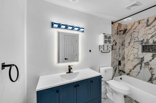 full bathroom featuring marble look tile flooring, vanity, toilet, and washtub / shower combination