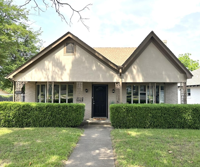 2009 Berwick Ave, Dallas, TX 75203 - view of front of house featuring brick siding, a front lawn, and a porch