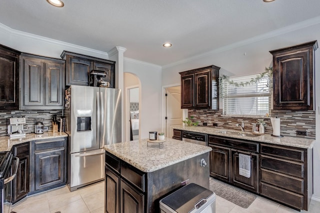 10804 Abbeyglen Ct, Fort Worth, TX 76052 - kitchen with stainless steel appliances, a sink, light tile patterned floors, arched walkways, and backsplash