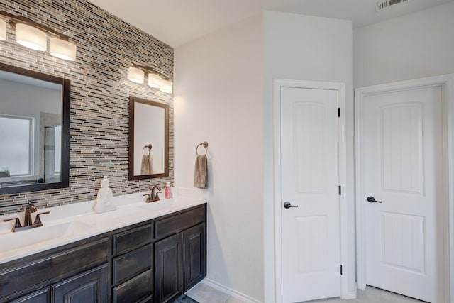 10804 Abbeyglen Ct, Fort Worth, TX 76052 - bathroom with double vanity, tasteful backsplash, and baseboards