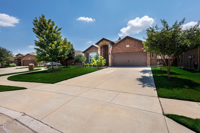 10804 Abbeyglen Ct, Fort Worth, TX 76052 - view of front of property with brick siding, driveway, a front yard, and an attached garage