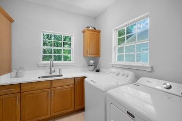 7095 Lance Ln, Eustace, TX 75124 - laundry room with independent washer and dryer, plenty of natural light, and cabinet space