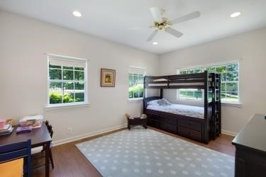 7095 Lance Ln, Eustace, TX 75124 - bedroom with wood finished floors, multiple windows, baseboards, recessed lighting, and a ceiling fan