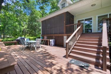 7095 Lance Ln, Eustace, TX 75124 - wooden terrace with outdoor dining space, stairs, and a sunroom