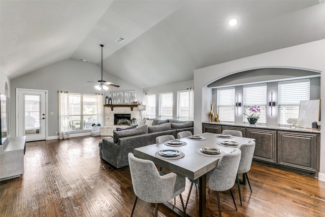 936 Mangrove Dr, Fate, TX 75087 - dining area featuring lofted ceiling, dark wood-type flooring, a fireplace, and ceiling fan