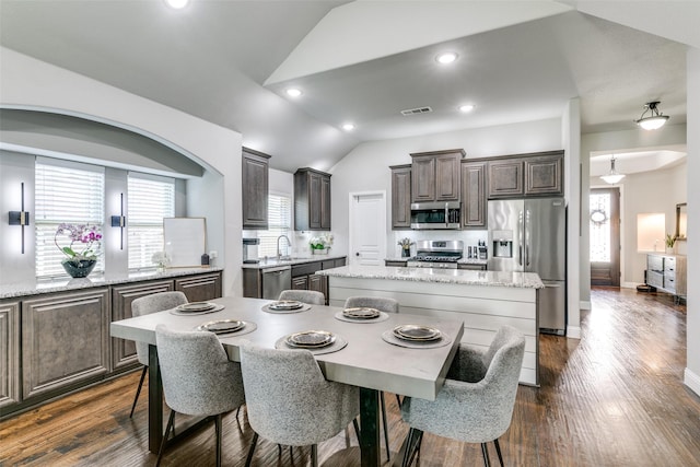 936 Mangrove Dr, Fate, TX 75087 - dining area featuring vaulted ceiling, healthy amount of natural light, dark wood-type flooring, and recessed lighting