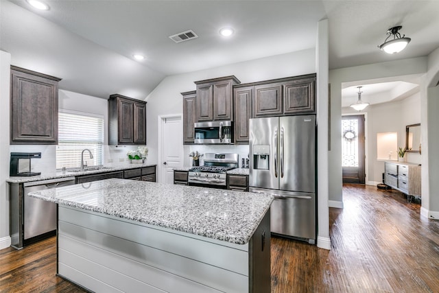 936 Mangrove Dr, Fate, TX 75087 - kitchen with appliances with stainless steel finishes, a sink, dark brown cabinetry, light stone countertops, and healthy amount of natural light