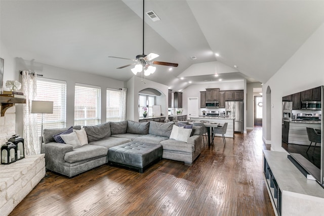 936 Mangrove Dr, Fate, TX 75087 - living area featuring a ceiling fan, arched walkways, dark wood-style flooring, and high vaulted ceiling