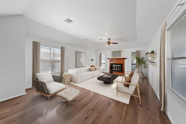 1300 Chapel Downs Rd, Waco, TX 76712 - living area with wood finished floors, plenty of natural light, a glass covered fireplace, ceiling fan, and vaulted ceiling