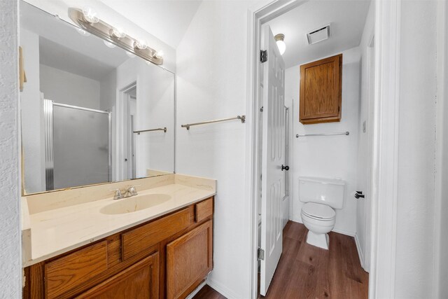 1300 Chapel Downs Rd, Waco, TX 76712 - full bathroom featuring wood finished floors, a stall shower, toilet, and vanity