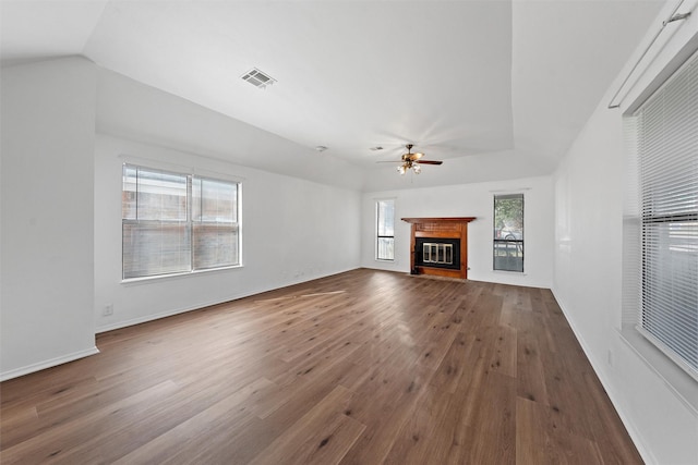 1300 Chapel Downs Rd, Waco, TX 76712 - unfurnished living room featuring ceiling fan, plenty of natural light, wood finished floors, a glass covered fireplace, and lofted ceiling
