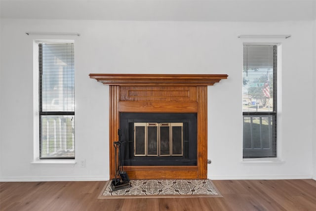 1300 Chapel Downs Rd, Waco, TX 76712 - detailed view of a fireplace with flush hearth, wood finished floors, and baseboards