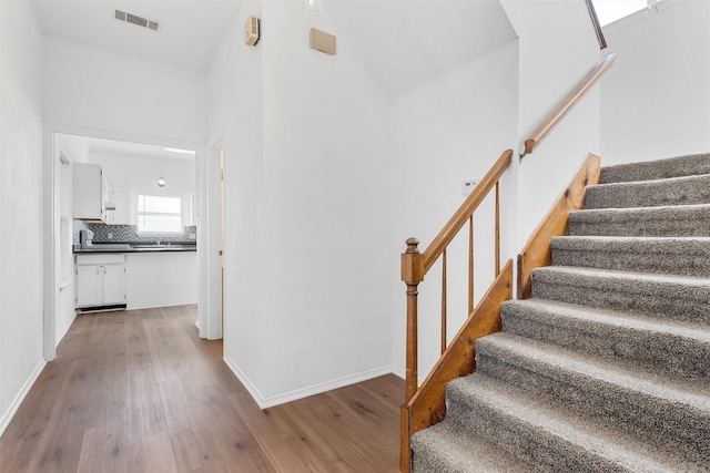 1300 Chapel Downs Rd, Waco, TX 76712 - stairs featuring wood finished floors, high vaulted ceiling, and baseboards