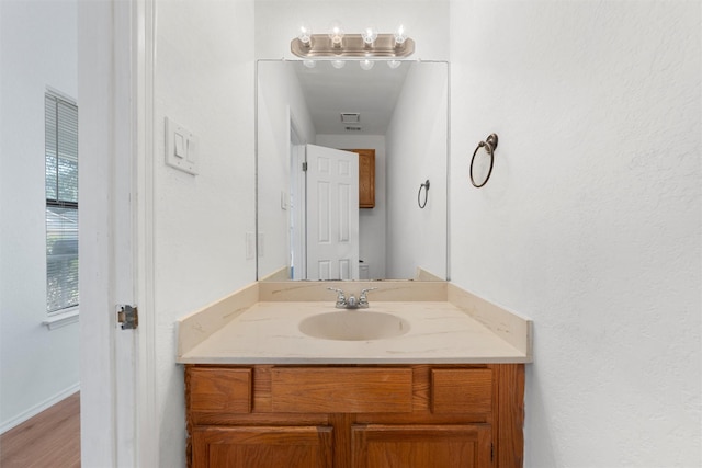1300 Chapel Downs Rd, Waco, TX 76712 - bathroom with vanity, toilet, wood finished floors, and baseboards