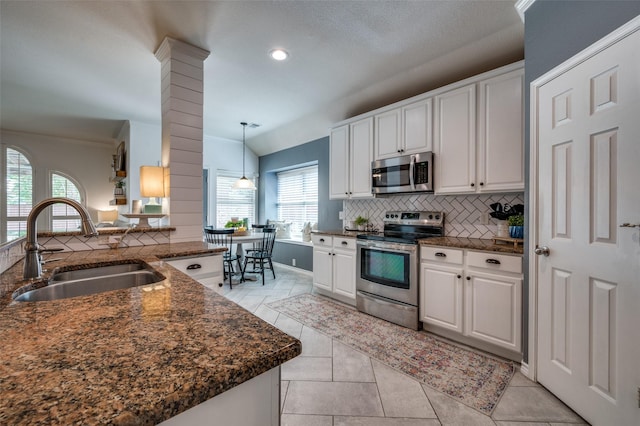 8209 Clear Bay Dr, Mckinney, TX 75072 - kitchen with appliances with stainless steel finishes, a sink, decorative backsplash, white cabinetry, and recessed lighting