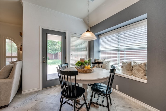 8209 Clear Bay Dr, Mckinney, TX 75072 - dining area featuring crown molding, light tile patterned flooring, healthy amount of natural light, and baseboards