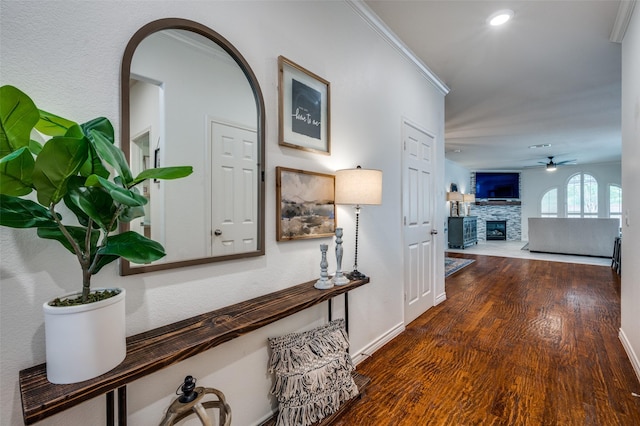 8209 Clear Bay Dr, Mckinney, TX 75072 - hallway with wood finished floors, arched walkways, baseboards, and crown molding
