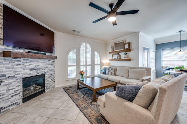 8209 Clear Bay Dr, Mckinney, TX 75072 - living area with a ceiling fan, a fireplace, ornamental molding, light tile patterned floors, and baseboards