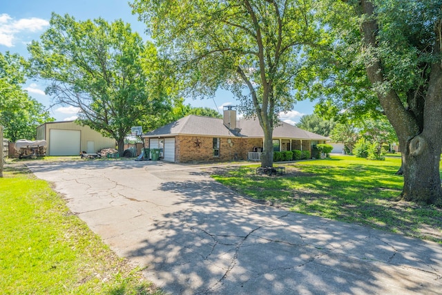 916 Rachelle Dr, Red Oak, TX 75154 - view of front of home featuring a front yard, a chimney, a detached garage, an outbuilding, and brick siding
