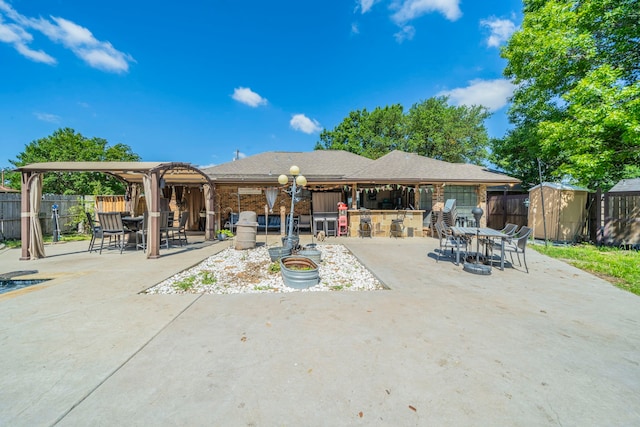 916 Rachelle Dr, Red Oak, TX 75154 - rear view of property featuring a patio, a storage shed, a fenced backyard, and an outdoor structure