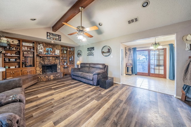 916 Rachelle Dr, Red Oak, TX 75154 - living area with a fireplace, wood finished floors, a ceiling fan, a textured ceiling, and baseboards