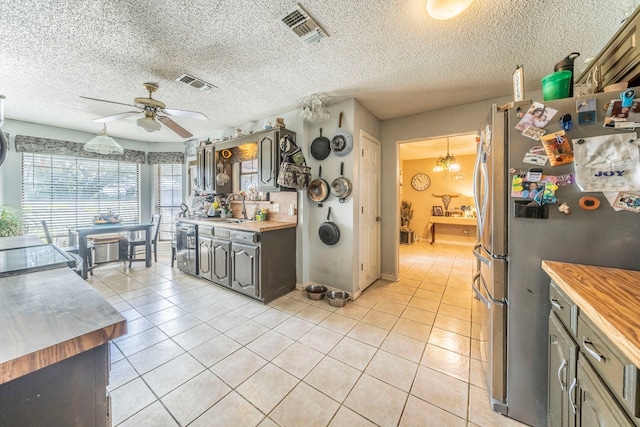 916 Rachelle Dr, Red Oak, TX 75154 - kitchen with freestanding refrigerator, wooden counters, ceiling fan, light tile patterned floors, and a sink