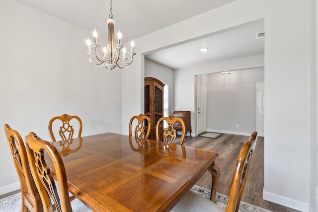 2040 Gleaner Dr, Rockwall, TX 75032 - dining room featuring wood finished floors, a chandelier, and baseboards