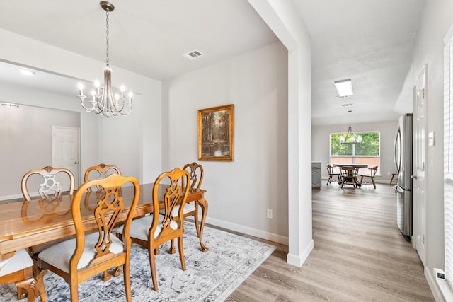 2040 Gleaner Dr, Rockwall, TX 75032 - dining space with a chandelier, light wood finished floors, and baseboards