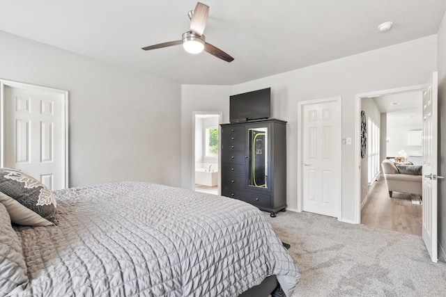 2040 Gleaner Dr, Rockwall, TX 75032 - bedroom with light colored carpet, ceiling fan, ensuite bath, and baseboards