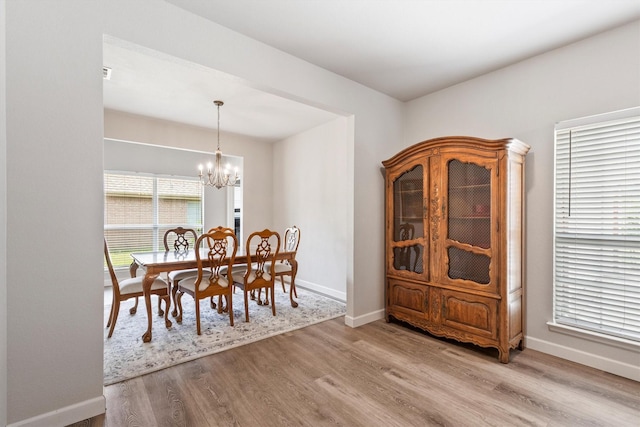 2040 Gleaner Dr, Rockwall, TX 75032 - dining space with a chandelier, wood finished floors, and baseboards